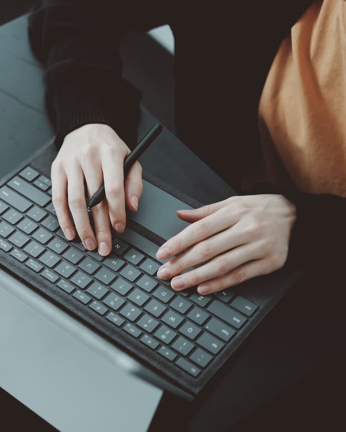 Person typing on keyboard.